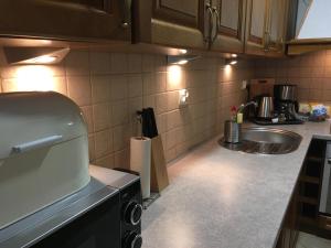a kitchen with a sink and a counter top at Apartament Gęsie Piórko in Jastrzębia Góra +36 photos