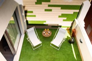 an attic room with two chairs and a table at Voghe Premium Flats in Valencia