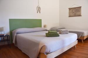 a bedroom with two beds with towels on them at B&B DEL VIAGGIATORE in Rovereto