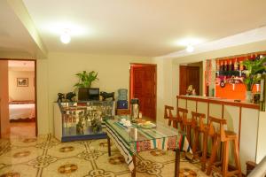 a dining room with a glass table and chairs at Samaykuy Bed and Breakfast in Urubamba +105 photos