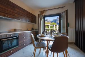 a kitchen with a table and chairs and a window at Harmony in Kalabaka