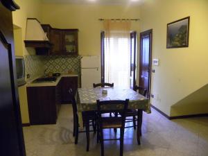 a kitchen with a table and chairs and a kitchen with a table and a kitchen at Case Vacanze Albamarina in Lipari