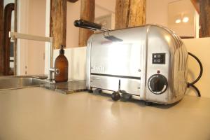 a toaster sitting on top of a kitchen counter at Bail mobilité appartement Louvre Palais Royal in Paris