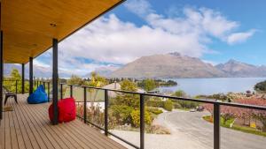 a balcony with a view of a lake and mountains at World Class Views in Queenstown