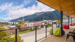 a balcony with a view of a lake and mountains at World Class Views in Queenstown