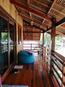 a room with a wooden deck and a wooden floor at Ilakai Hostel in General Luna
