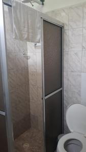 a bathroom with a shower stall with a toilet at Pousada Siroba Beira Rio in Morretes