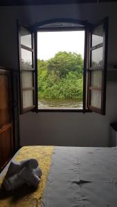 Cama ou camas em um quarto em Pousada Siroba BEIRA RIO