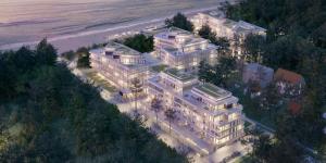 an aerial view of a large building on the beach at Dune Resort - B in Mielno