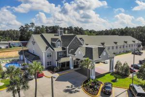 an aerial view of a large house with a parking lot at Country Inn & Suites by Radisson, Biloxi-Ocean Springs, MS in Ocean Springs