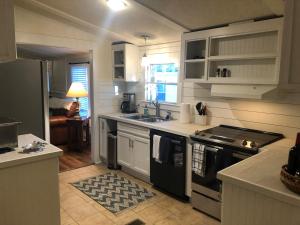 a kitchen with white cabinets and a stove top oven at Beaufort SC New Renovation, Close to Parris Island, Historic Downtown, Beautiful Beaches, Sleeps 8 in Beaufort
