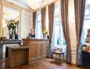 a salon with a fireplace in a room with windows at Hôtel Spa Marotte in Amiens +79 photos