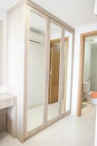 a sliding glass door in a bathroom with a toilet at Apatel The Mansion Jasmine Tower Aurora J31I in Jakarta