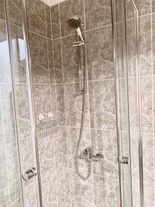 a shower with a glass door and a shower constructorangering at Old Town Apartment-City Centre in Warsaw