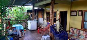 a room with a patio with hammocks and a refrigerator at Cabañas Maikü Selva in Puerto Nariño