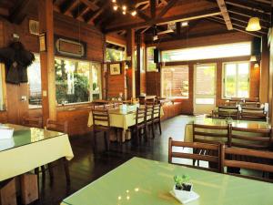 a dining room with tables and chairs in a restaurant at 5 KM Villa in Renai