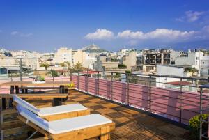 a balcony with tables and a view of a city at Central Stay Athens in Athens