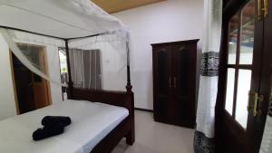 Una cama o camas en una habitación de Bandulas Beach House