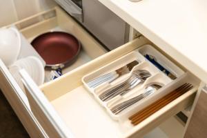 a drawer in a refrigerator filled with utensils at GRAND BASE Hiroshima Ekimae in Hiroshima