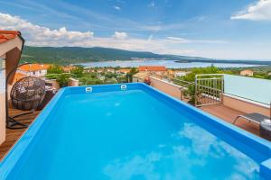 a pool on the balcony of a house with a view at Villa Antonia in Kornić