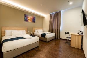 Postel nebo postele na pokoji v ubytování 1 Orange Hotel Kuchai Lama KUALA LUMPUR + 13 fotografií