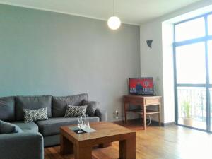 a living room with a couch and a coffee table at Résidence Le Hublot in Antananarivo