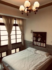 a bedroom with a bed and a large window at Shennong 147 in Tainan