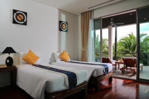 a bedroom with two beds and a balcony at Kata gardens luxury 2bedroom 4B Near Kata Noi Beach in Kata Beach +42 photos