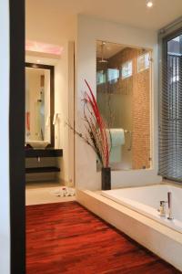 a bathroom with a large tub and a large mirror at Kata gardens luxury 2bedroom 4B Near Kata Noi Beach in Kata Beach