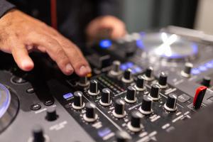 a man is playing music on a mixing console at Grand Washington Hotel in Istanbul