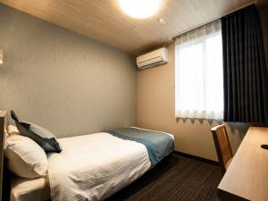Postel nebo postele na pokoji v ubytování Hotel AreaOne Izumo