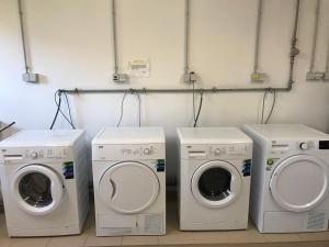 three washing machines and a washer and dryer in a room at Waarkstrooss 12 in Welscheid