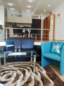 a living room with a couch and a table and chairs at LUX & Comfort in Košice