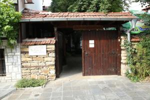 an entrance to a building with a wooden door at Oazis Family Hotel in Lovech