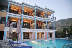 a hotel with a pool in front of it at Ethereal Villas Lefkas in Nydri