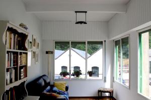a living room with two windows and a couch at Casa l'avia in Ribes de Freser