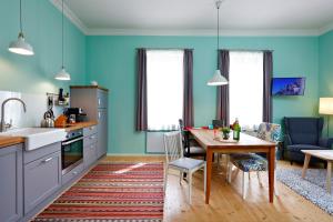 a kitchen with blue walls and a table and a dining room at Urlaub am Bahnhof in Annaberg