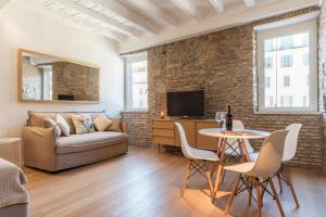 a living room with a couch and a table at Campo De' Fiori Apartment - Charme Homes in Rome