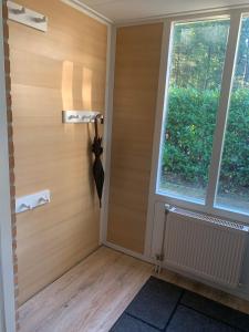 ein leeres Zimmer mit einer Tür und einem Fenster in der Unterkunft Veenwaterhuisje 3-5 in Putten