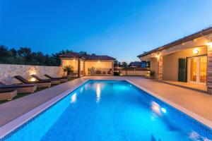 a swimming pool in the backyard of a house at Villa Idassa in Bri&scaron;evo