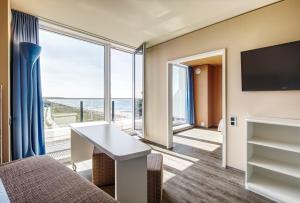 a hotel room with a view of the ocean at aja Warnemünde in Warnemünde