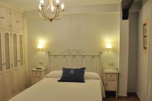 Posteľ alebo postele v izbe v ubytovaní Apartamentos Boutique Doña Maria La Brava