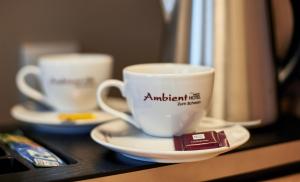 a coffee cup sitting on top of a coffee table at Ambient Hotel Zum Schwan in Gelsenkirchen
