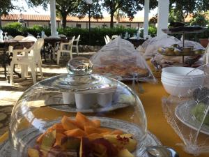 a table with plates of food in a glass jar at Corallo Country House in Noci