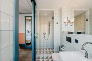 a bathroom with a shower and a sink at The July - Boat & Co in Amsterdam