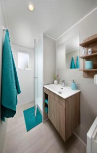 a bathroom with a sink and a shower at KNAUS Campingpark Bad Dürkheim in Bad Dürkheim +21 photos
