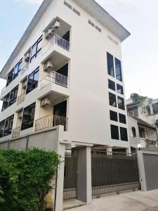 a white building with balconies on it at Baanrao Bangson in Bangkok