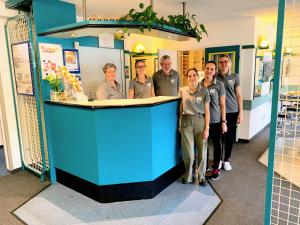 a group of people standing behind a blue counter at T3 Budget Zwickau in Zwickau