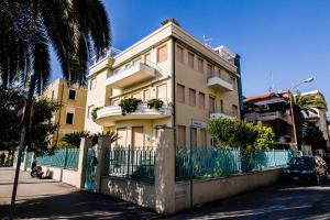 a building with a fence in front of it at Appartamento Cadore in San Benedetto del Tronto