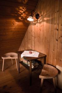 Habitación de madera con mesa y taburete en Cottage Trenta, en Bovec